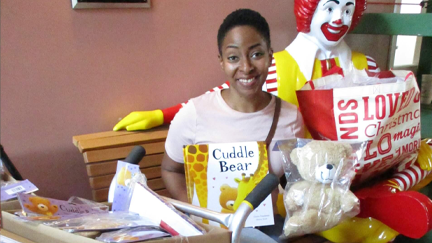 A volunteer poses with donations